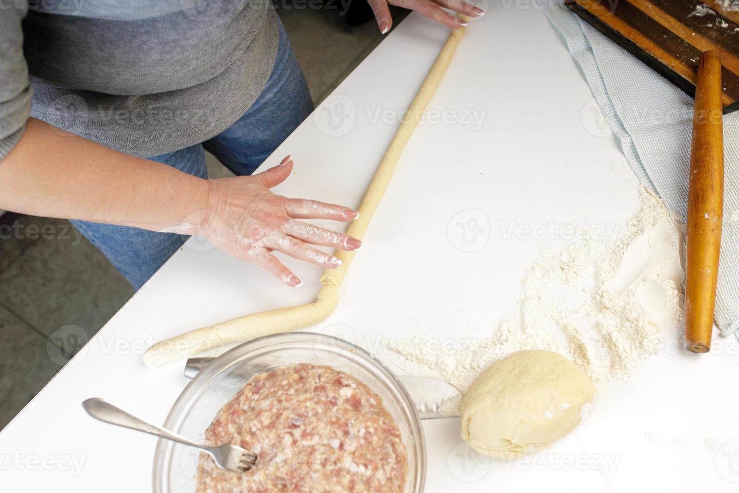 homemade dumplings in the kitchen without decorations. making dumplings with minced pork, beef and chicken photo