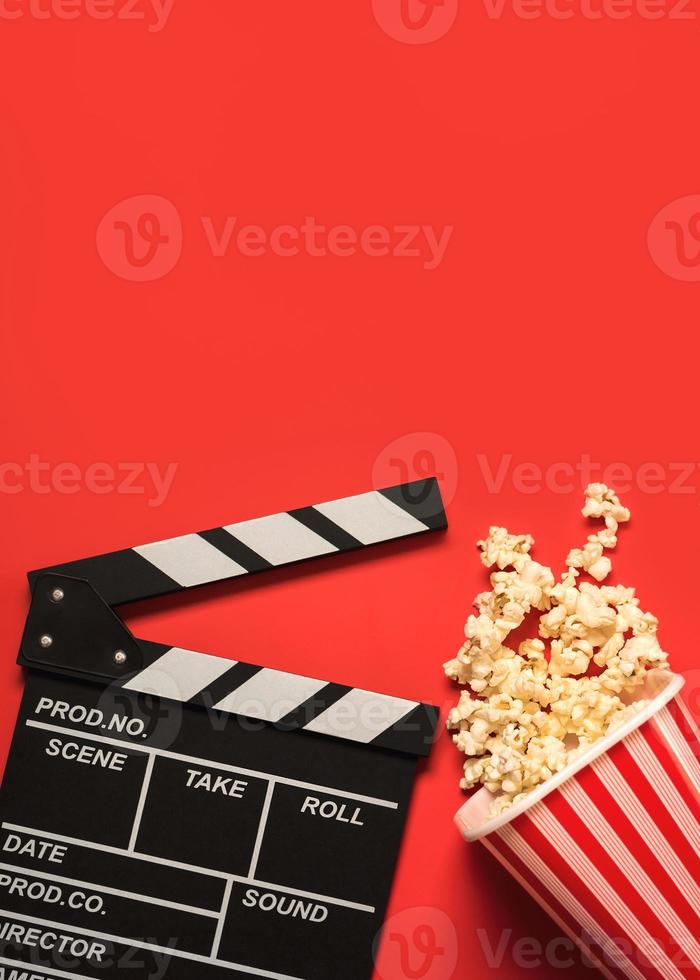 movie clapperboard with popcorn and space for text.Cinema concept background photo