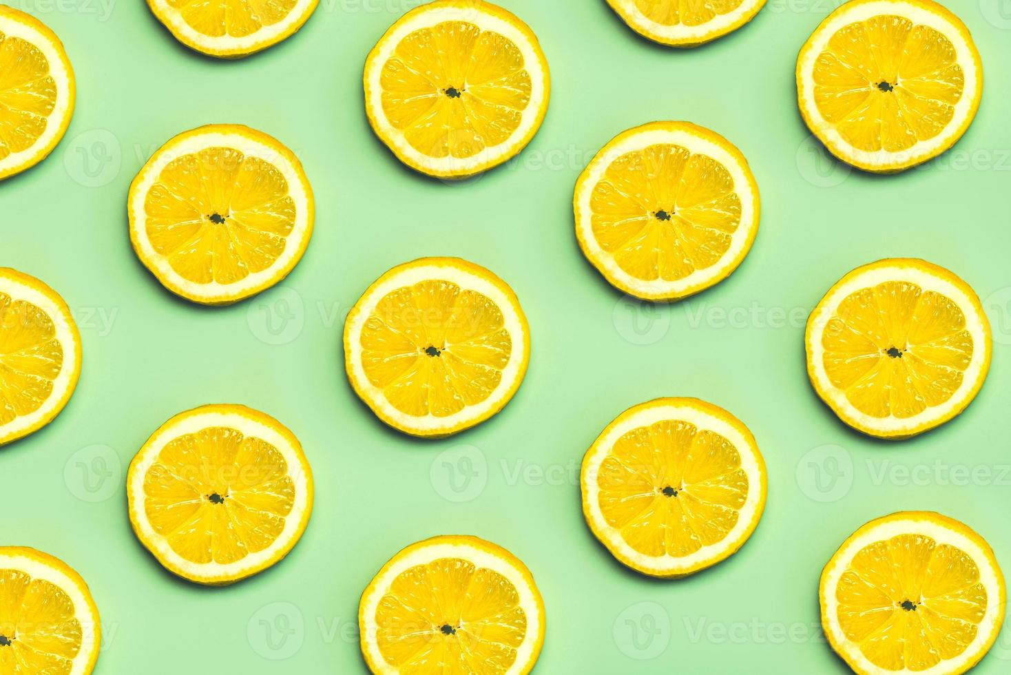 Top view of creative pattern made of lemons slices photo