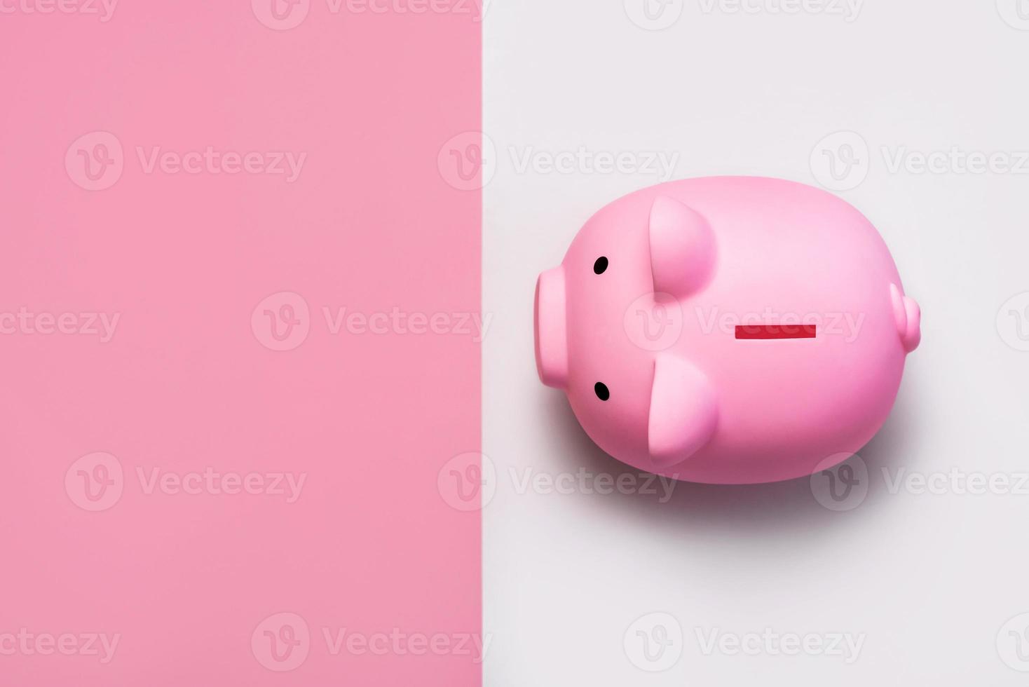 top view of pink piggy money bank with copy space photo