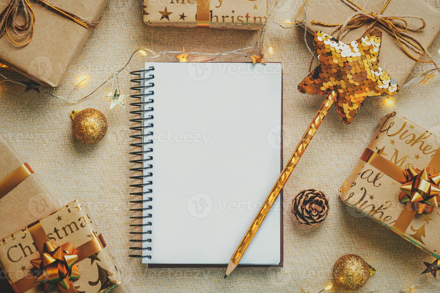 Merry Christmas. Top view of notebook with christmas gifts and christmas decorations.Christmas concept background photo