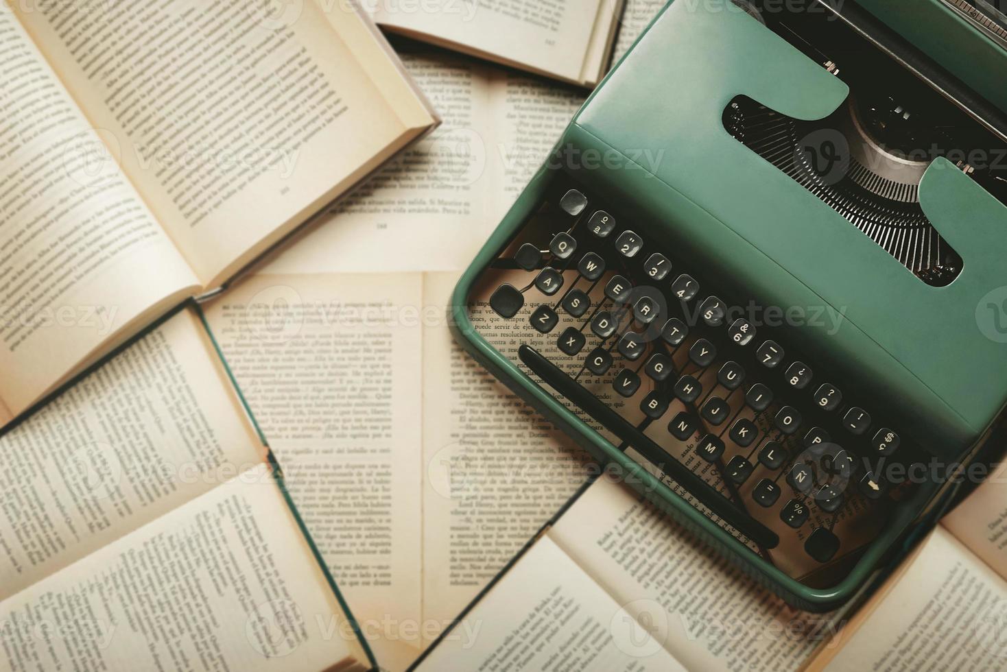 Top view of vintage typewriter with books and copy space photo