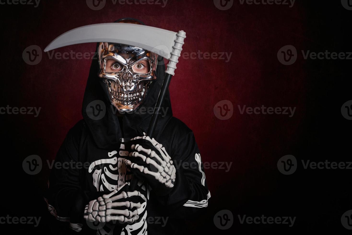 boy in skeleton costume on halloween photo