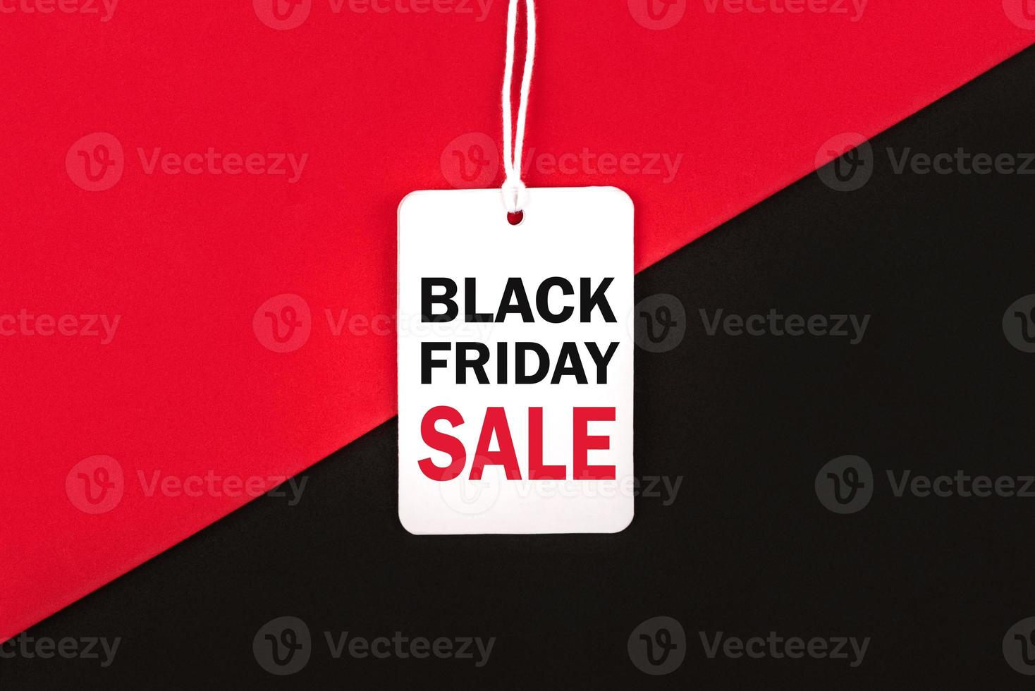 Black friday.Sale tag with text and the rope hanging on red and black background.Shopping concept photo