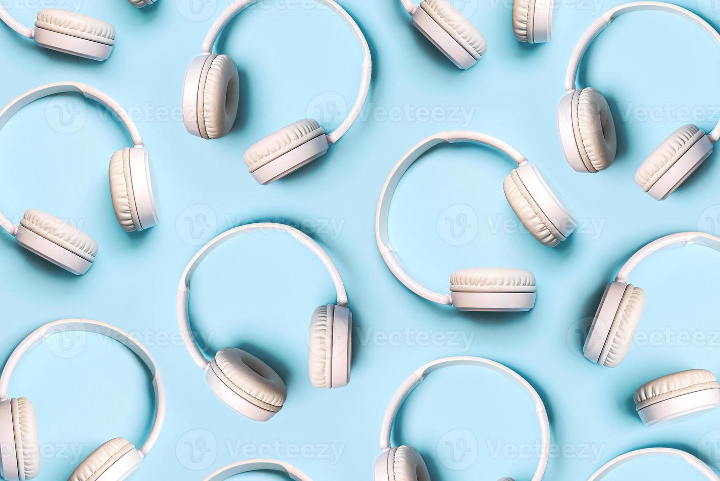 Top view of creative pattern made of white wireless headphones photo