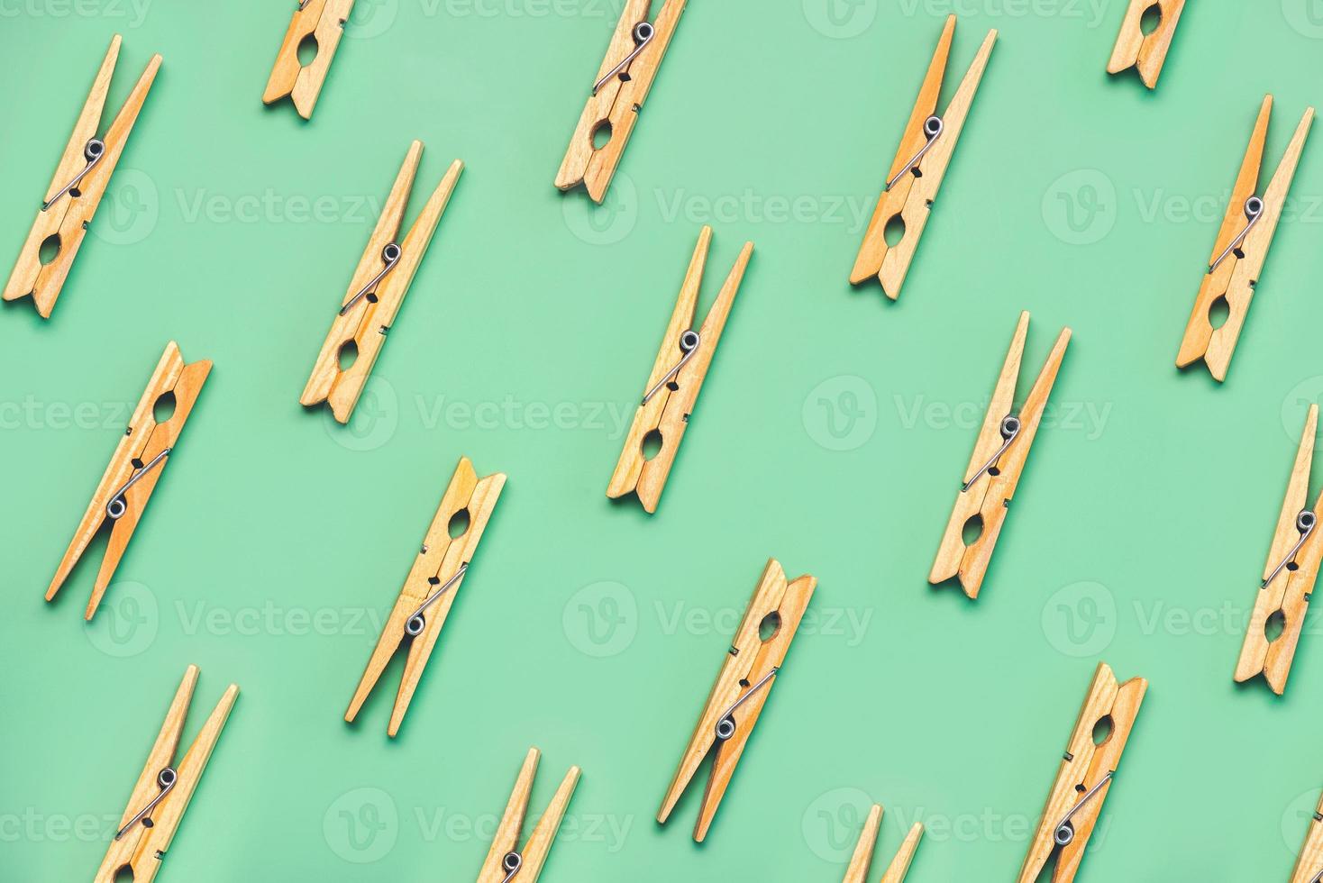Top view of creative pattern made of wooden clothespins photo