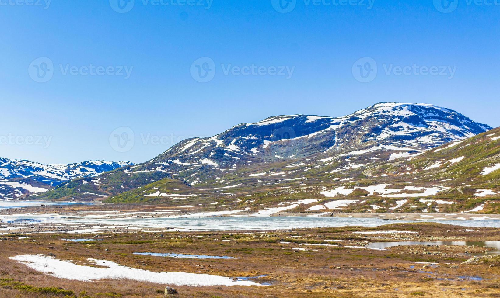 Amazing Vavatn lake panorama rough landscape snow mountains Hemsedal Norway. photo