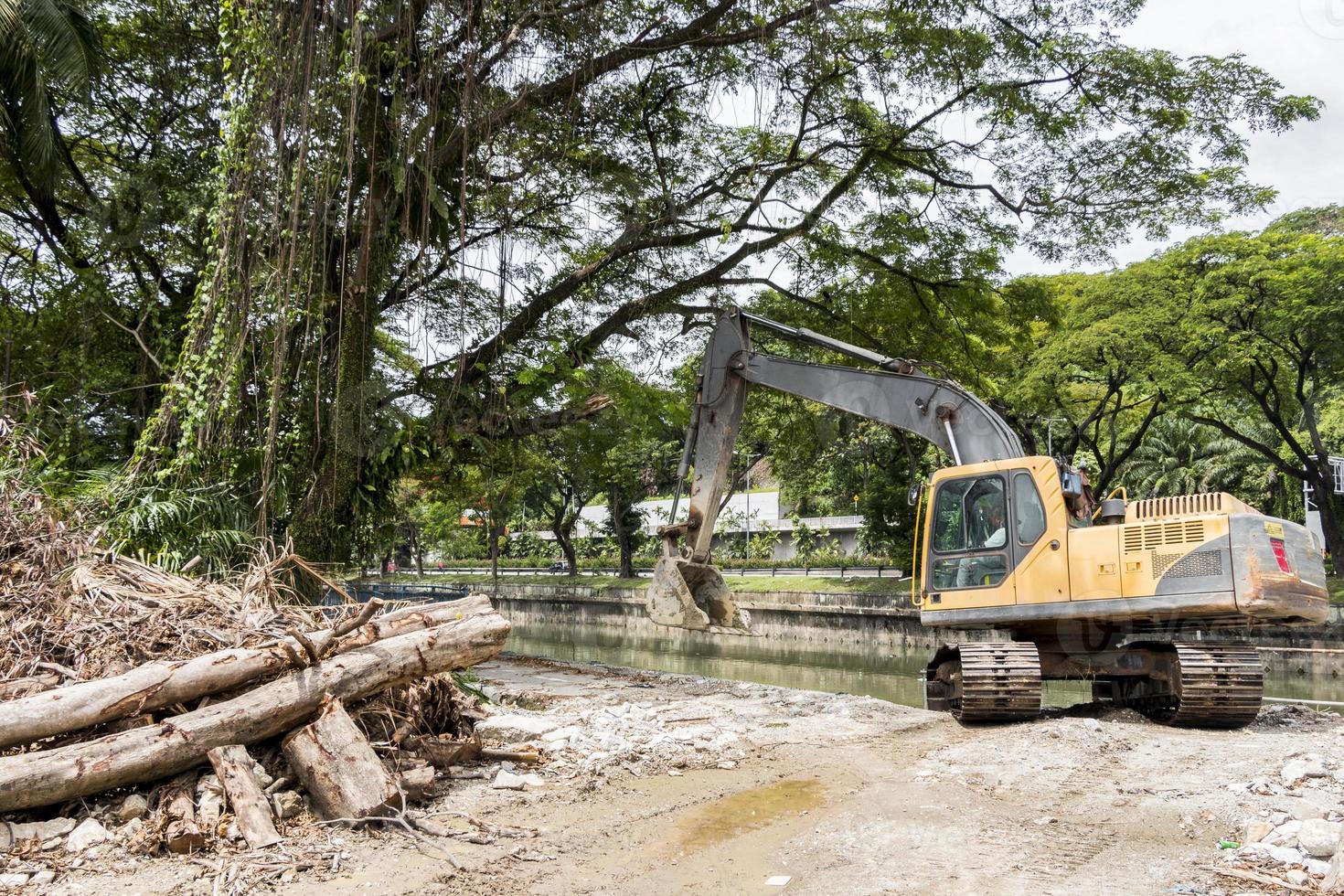 Excavator destroys nature and trees in Kuala Lumpur, Malaysia. photo