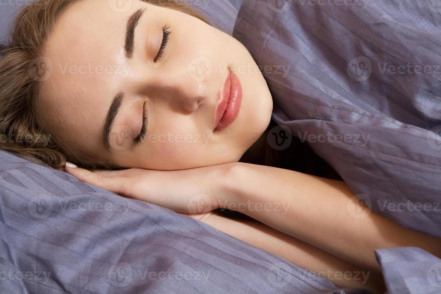 beautiful girl sleeps in the bedroom close up portrait photo