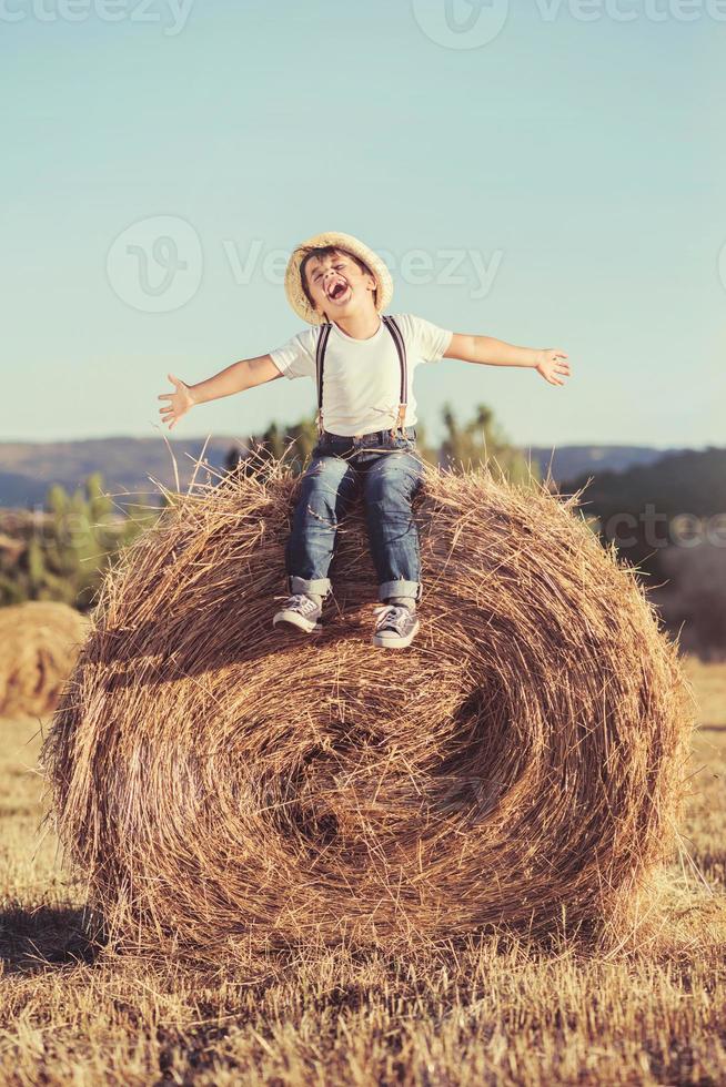 Kid playing in wheat field photo