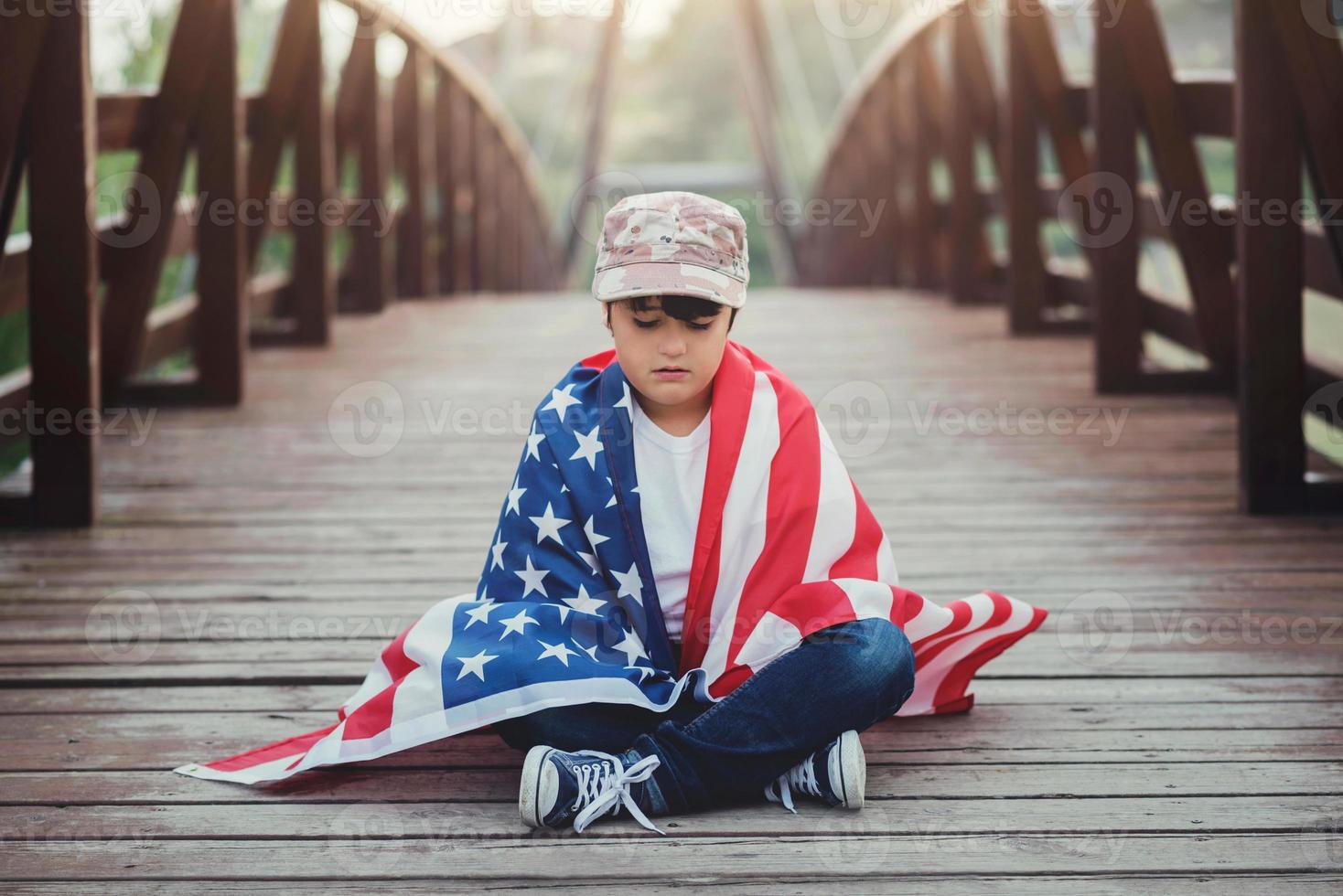 sad child with the flag of the United States photo