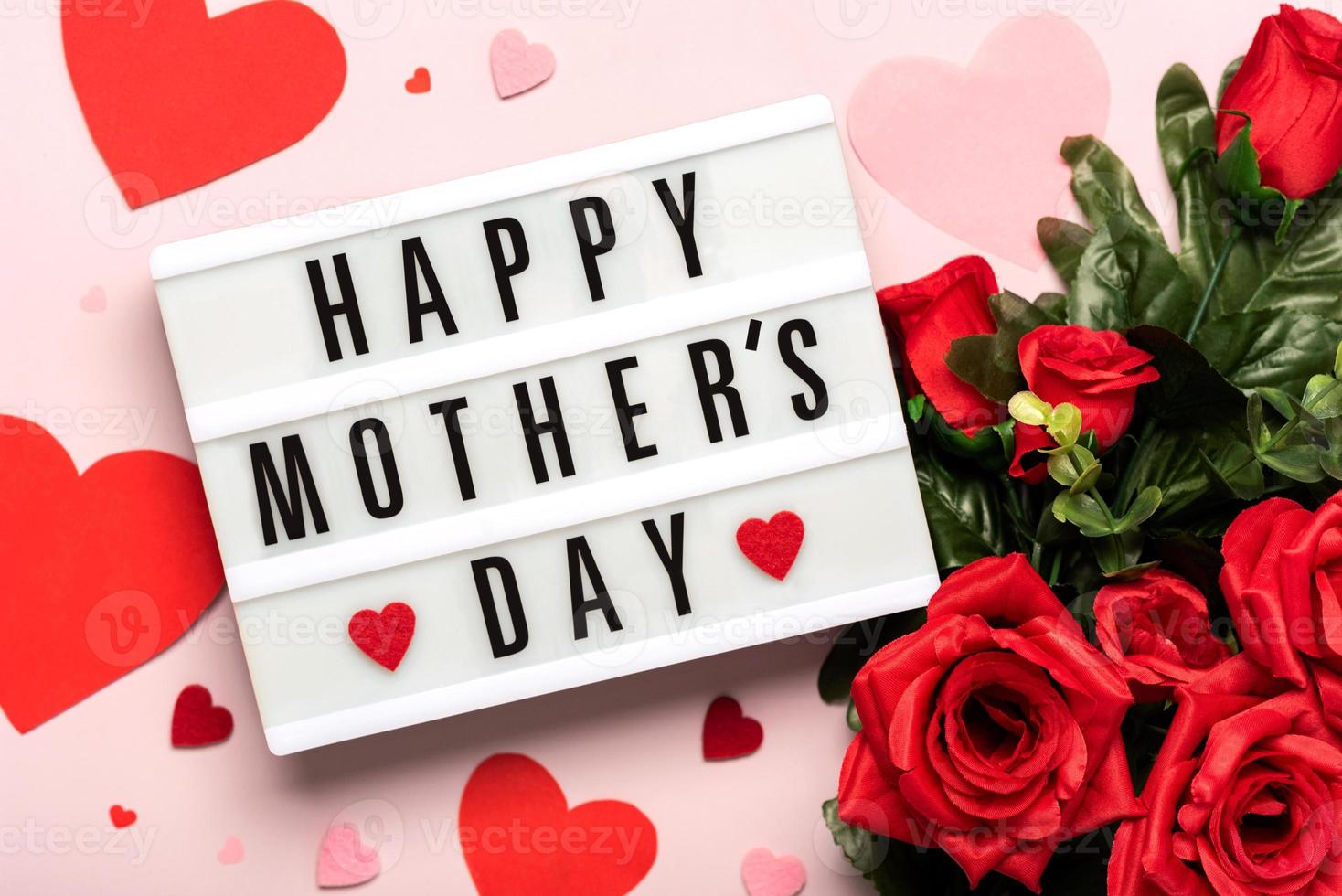 Happy Mother's Day.Lightbox with the word Happy Mother's Day next to hearts and bouquet of red red roses photo