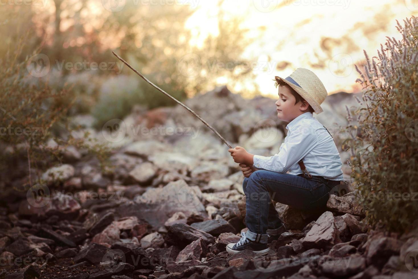 Pensive boy on the river photo