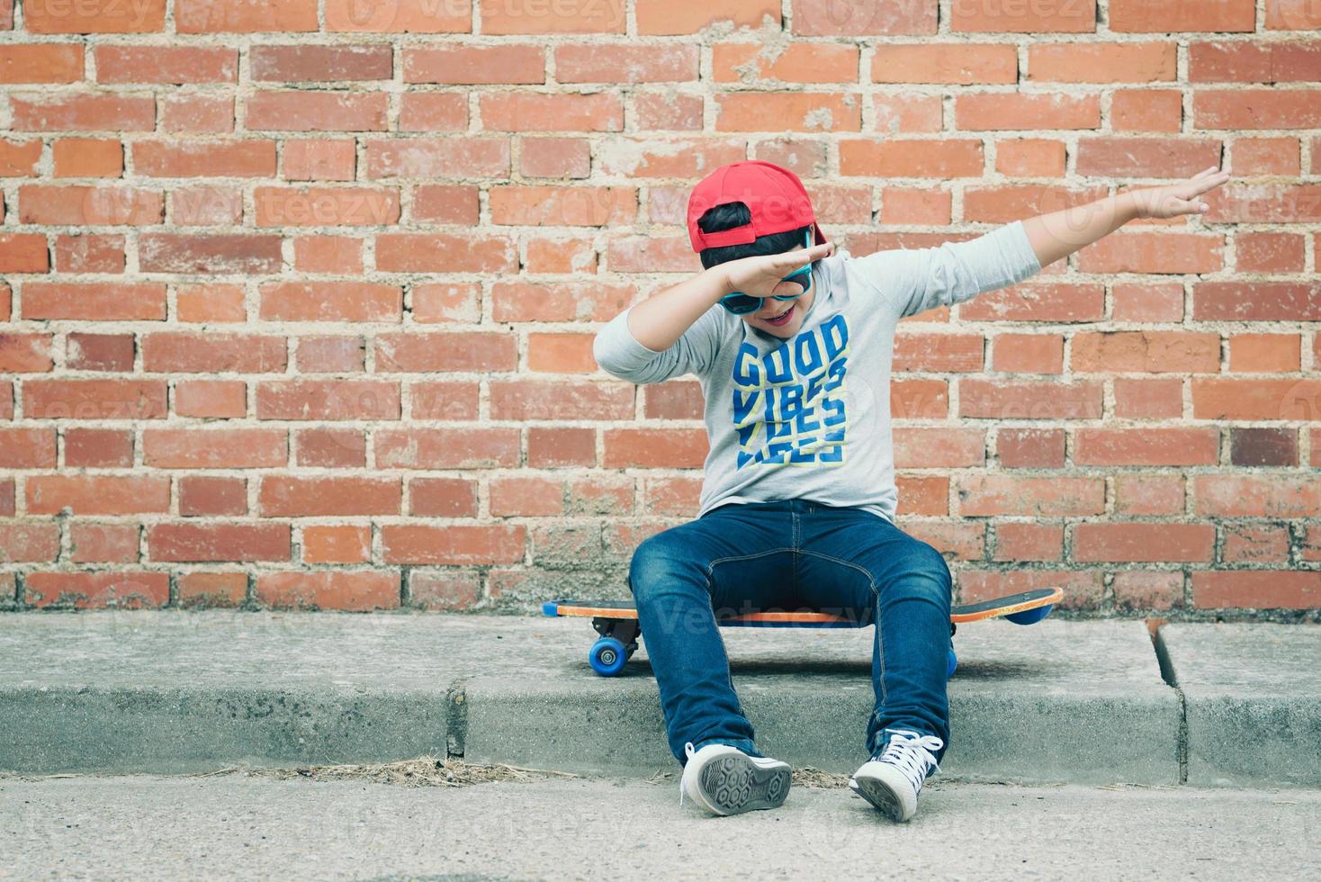 child with skateboard in the street photo