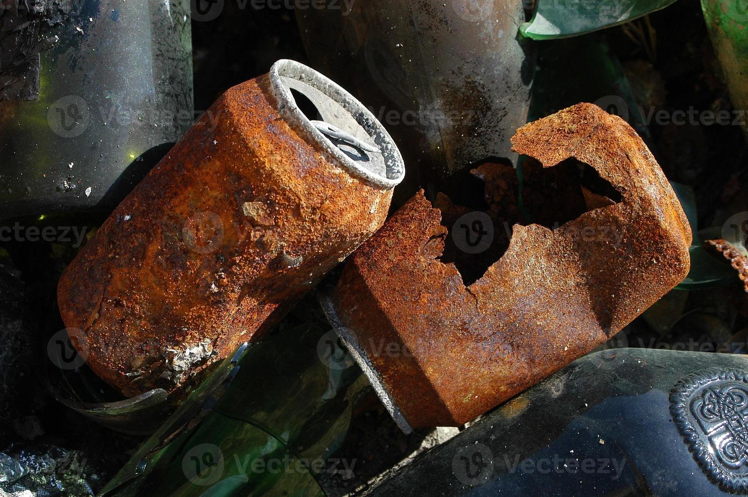 rusty cans on glass bottles photo