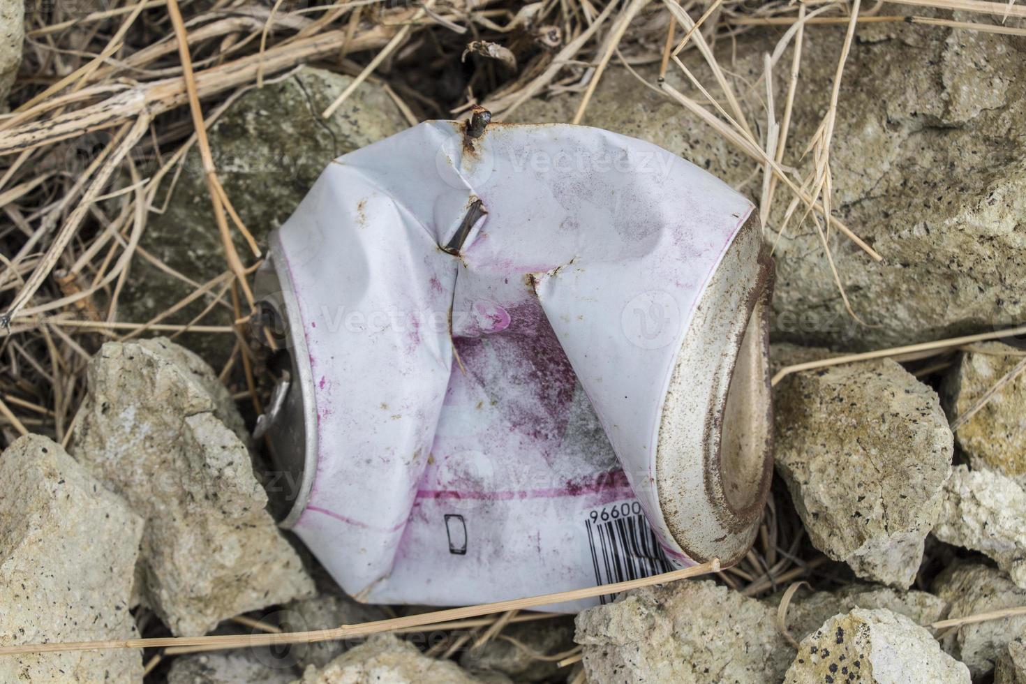 soda can thrown in the field photo