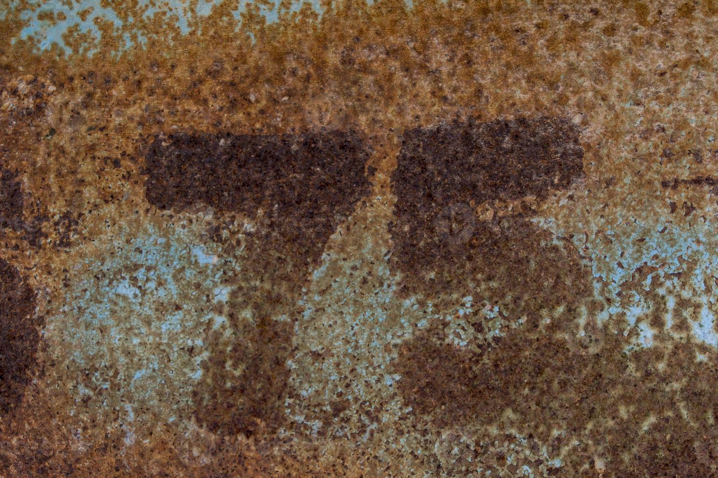 rusty number seventy five on rusty metal photo