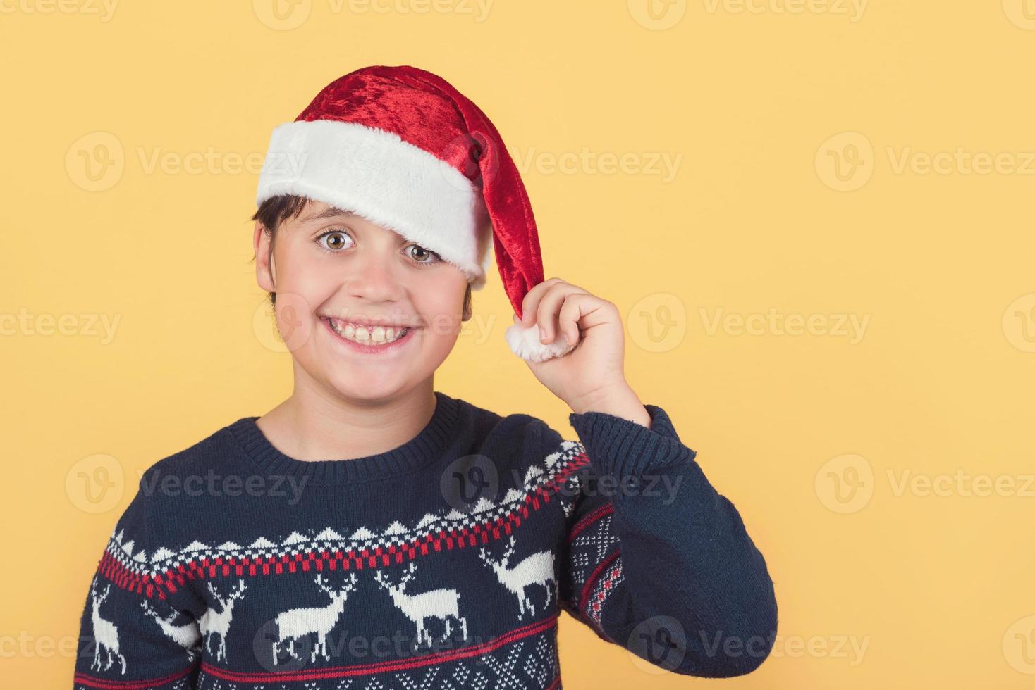 funny Child Wearing Christmas Santa Claus Hat photo