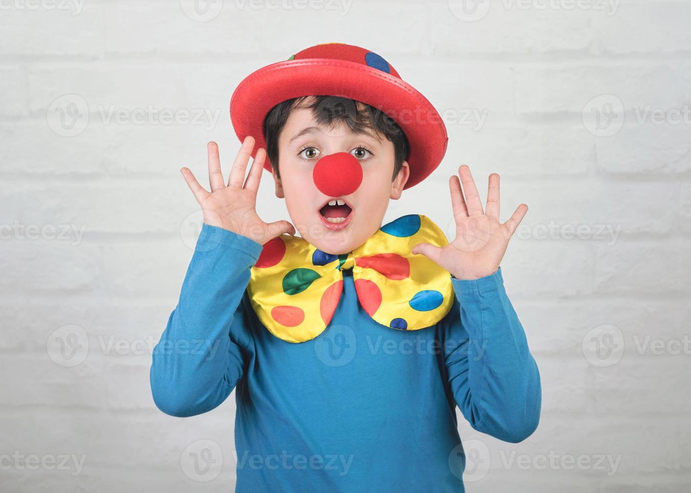 funny child with clown nose and hat photo