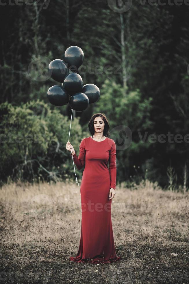 mujer joven con globos en el campo foto