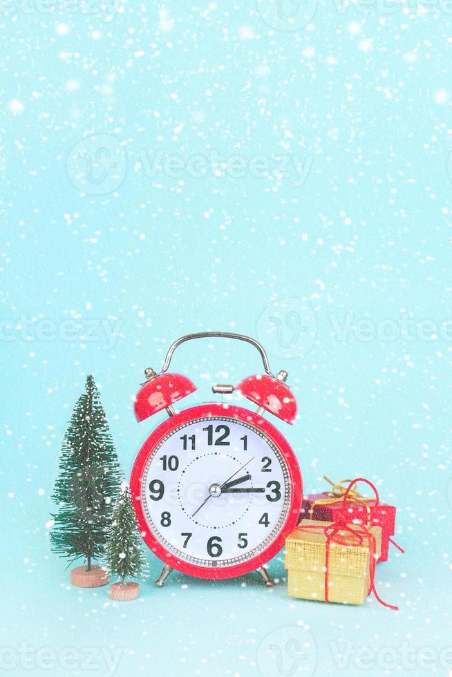alarm clock next to christmas tree and gifts,New Years Eve concept photo