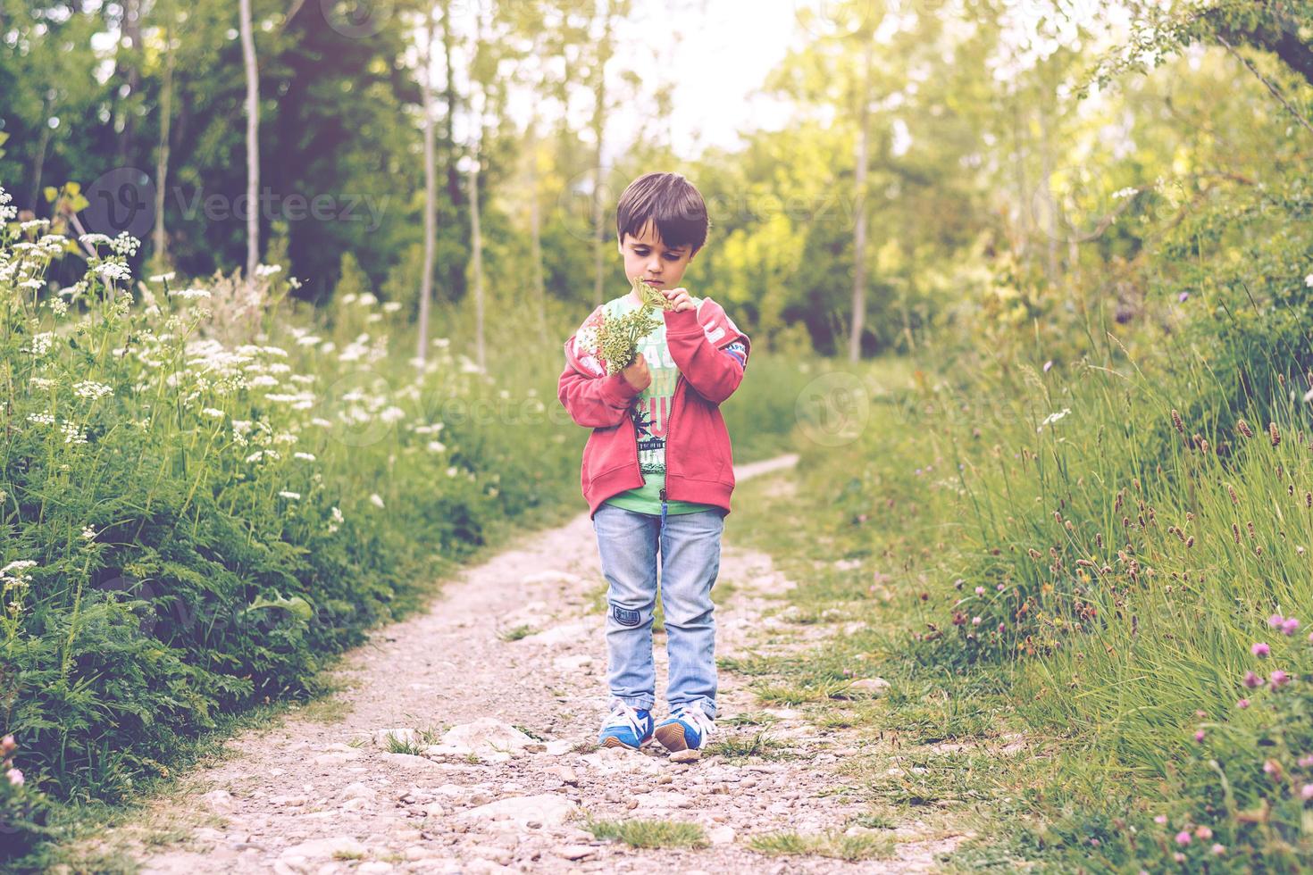 child with flowers in spring photo