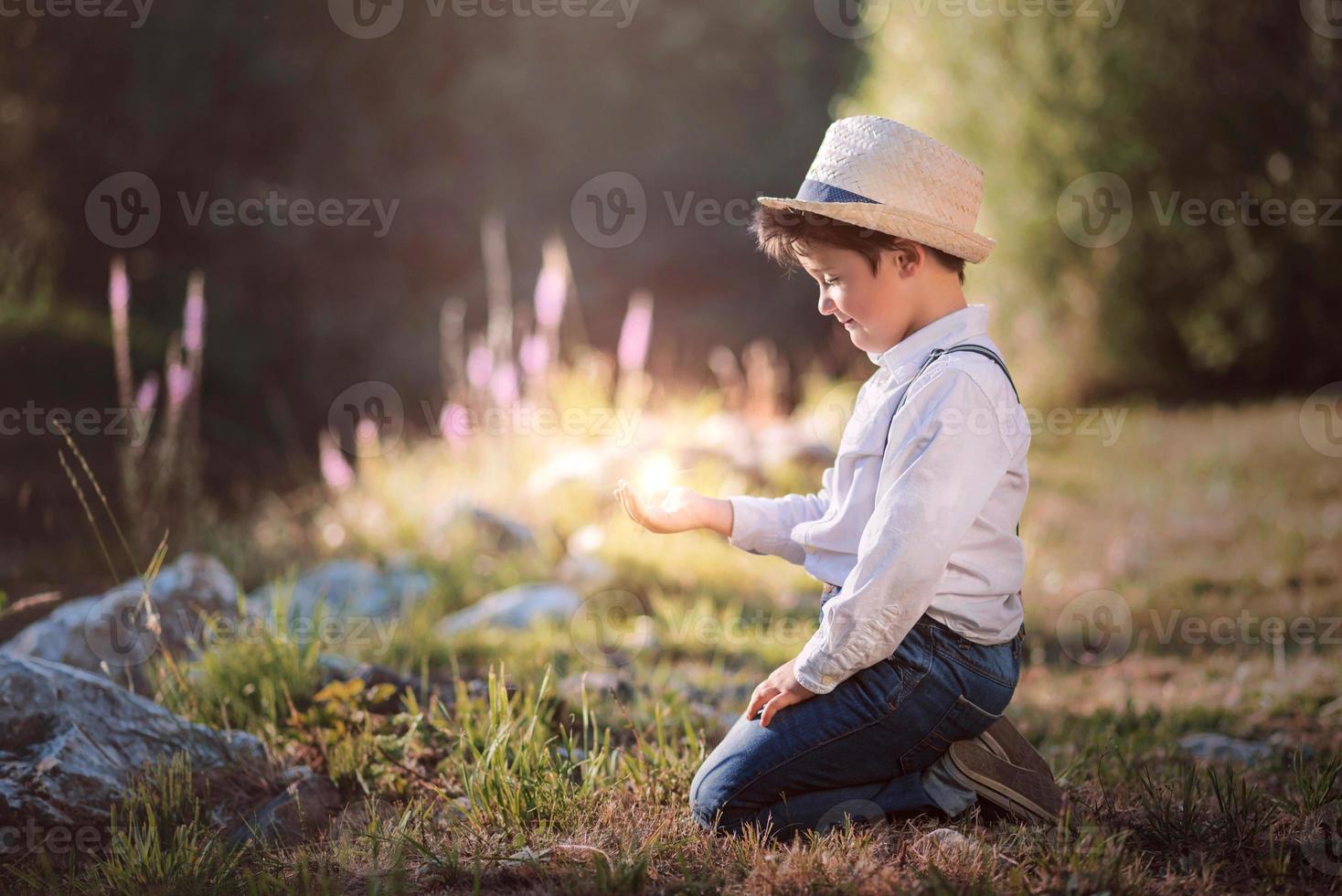 niño soñador sentado en el campo foto