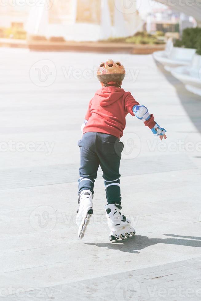 child outdoor roller skates in park photo