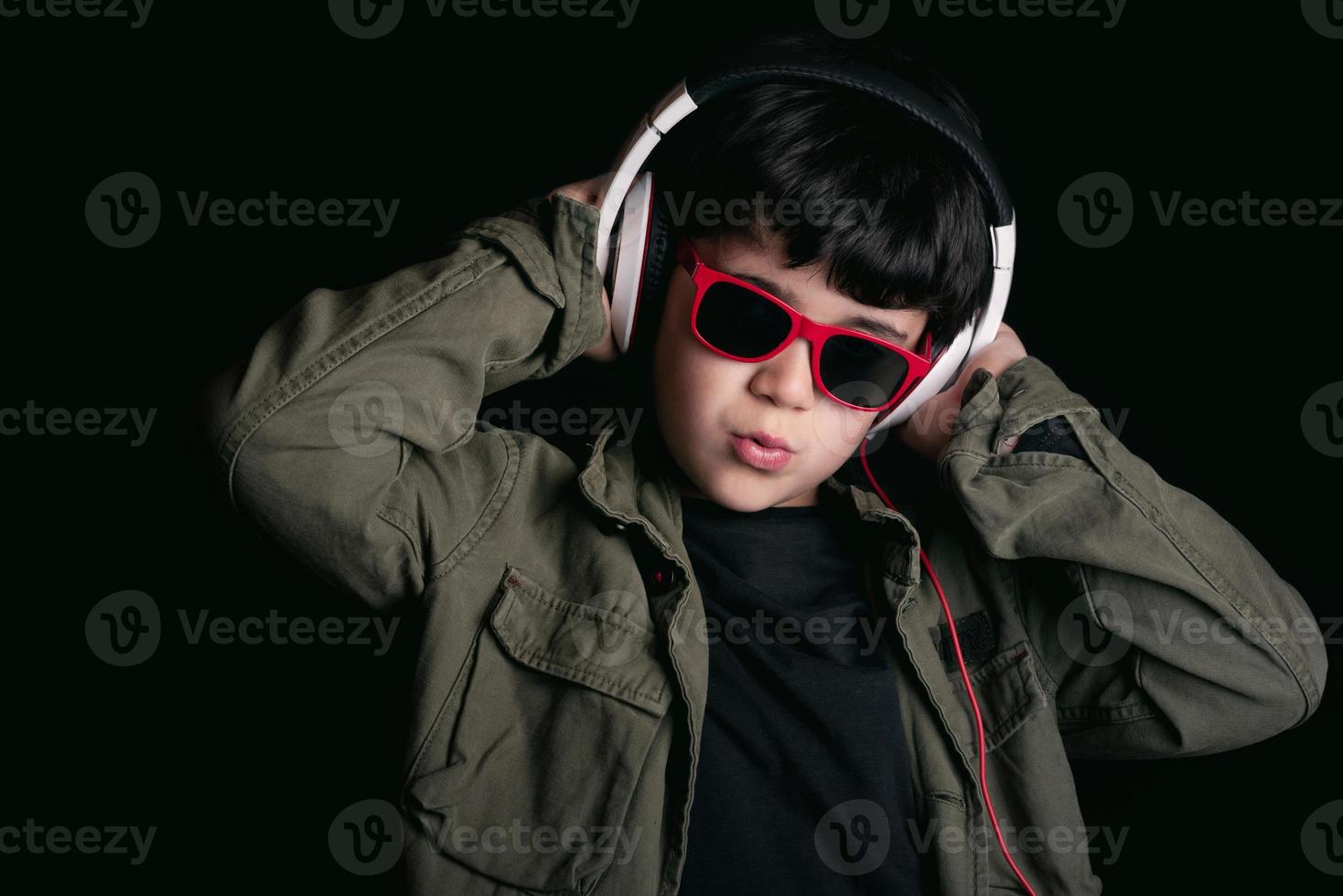 Boy listening to music with headphones photo