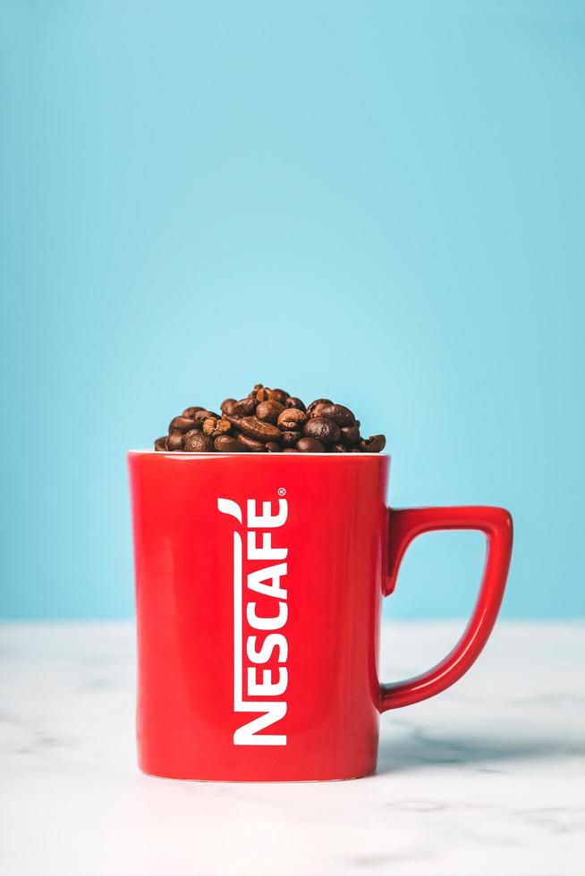 Red cup of Nescafe with coffee beans photo