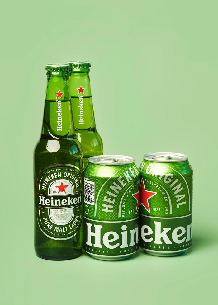 Heineken lager beer bottles and Heineken beer aluminum cans photo