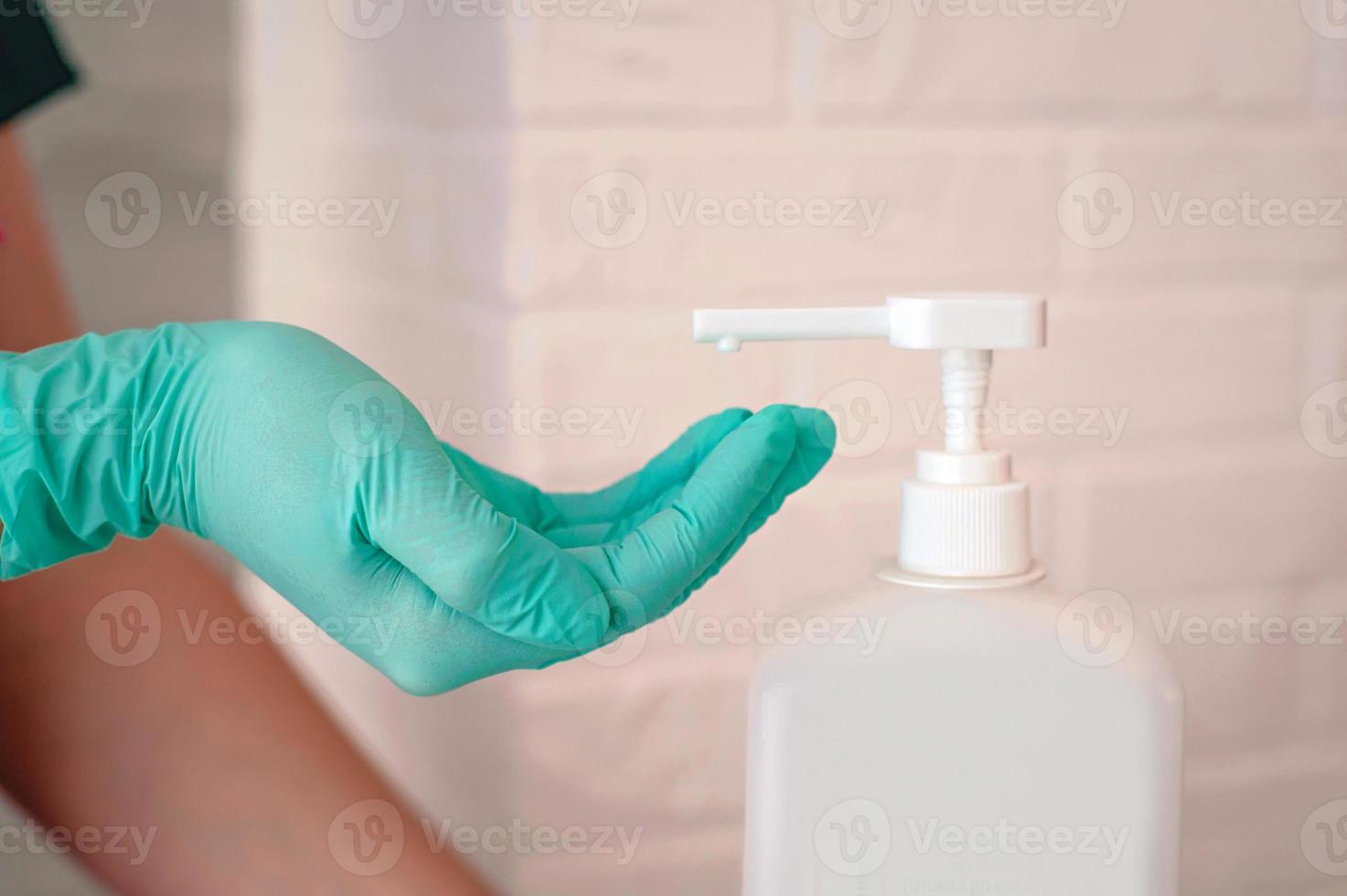 hands in latex gloves holding antiseptic bottle. Antiseptic bottle, safety, covid, cleanliness concept photo
