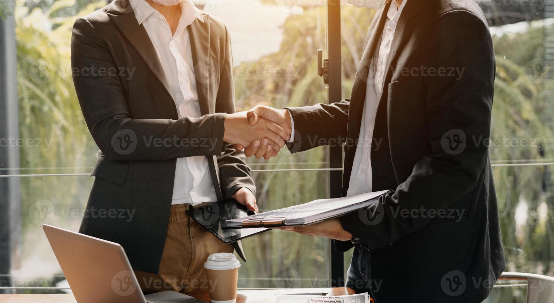 Business handshake closing a deal with blur background of people photo