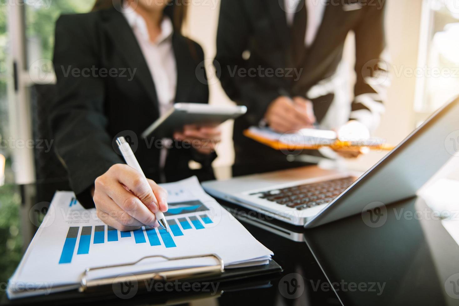 Business meeting time. Photo young account managers crew working with new startup project. Notebook on table.presentation