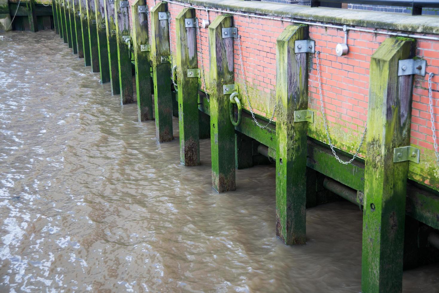 Old pier made of wood and bricks photo