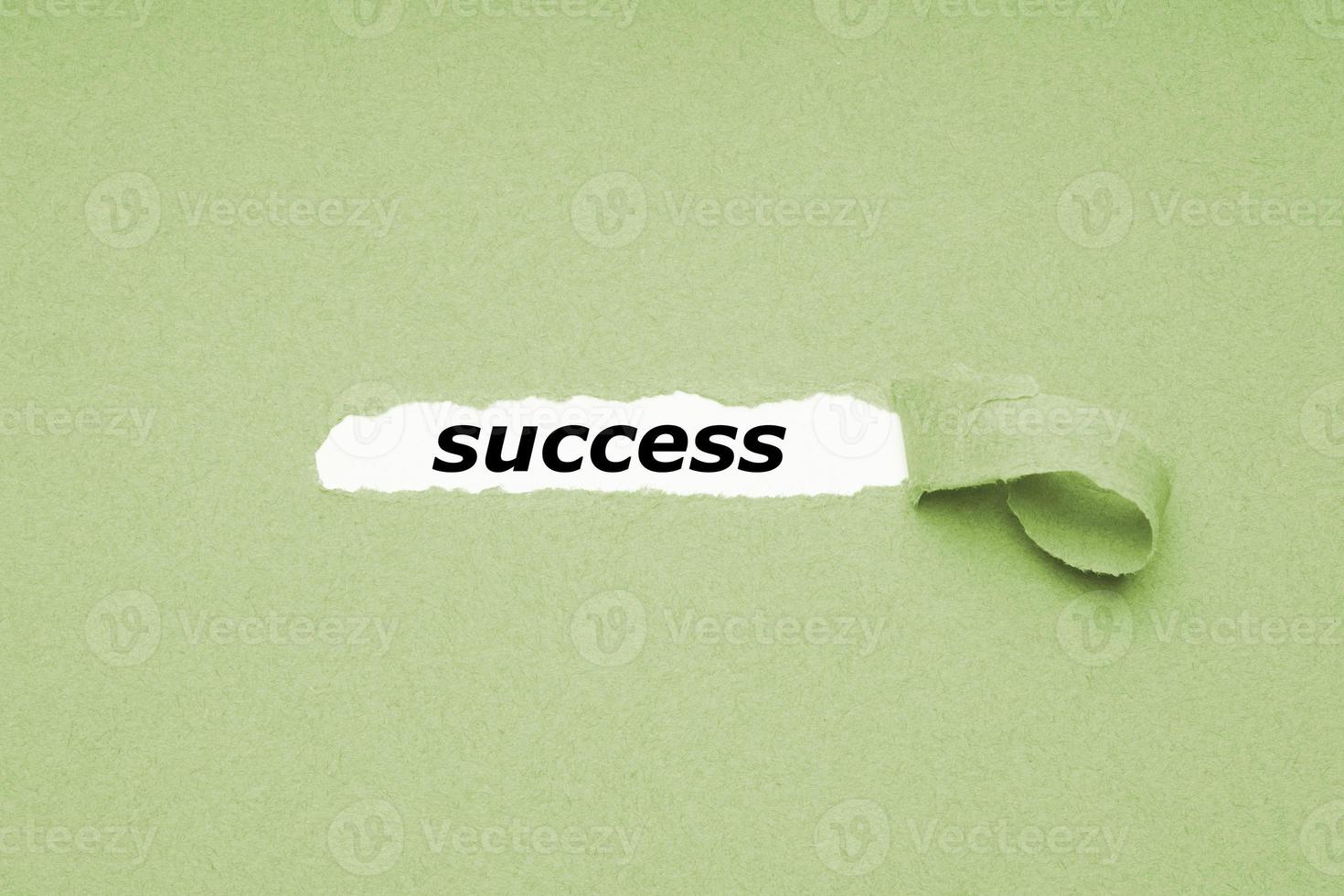 finding success concept - hole in paper background revealing hidden text photo