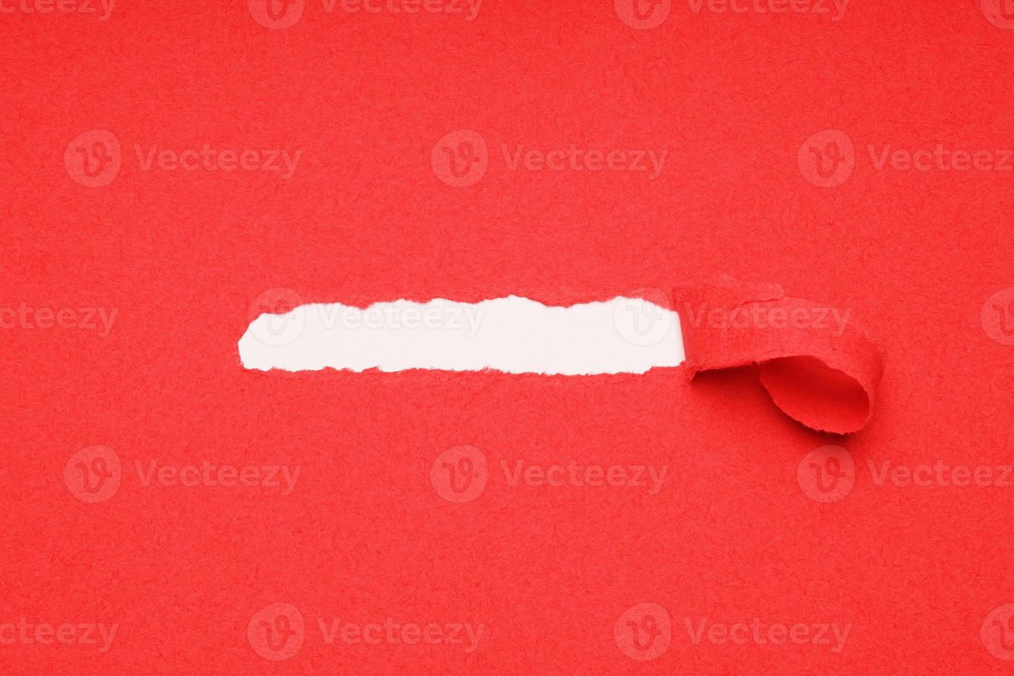 peel away ripped red paper to reveal hidden copy space underneath photo