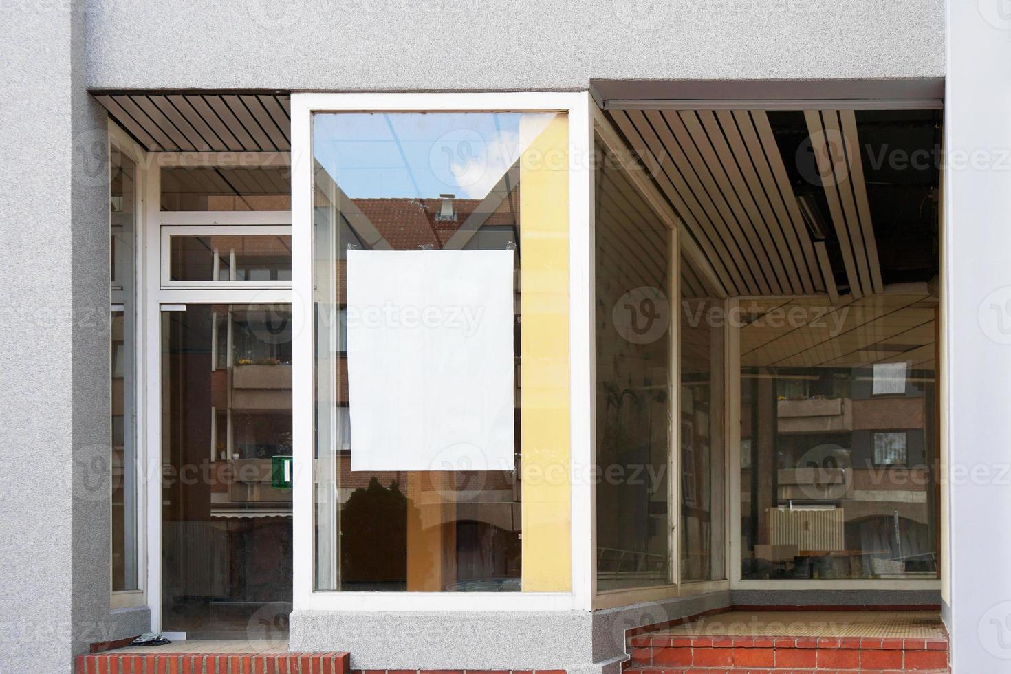 blank sign in empty store window photo