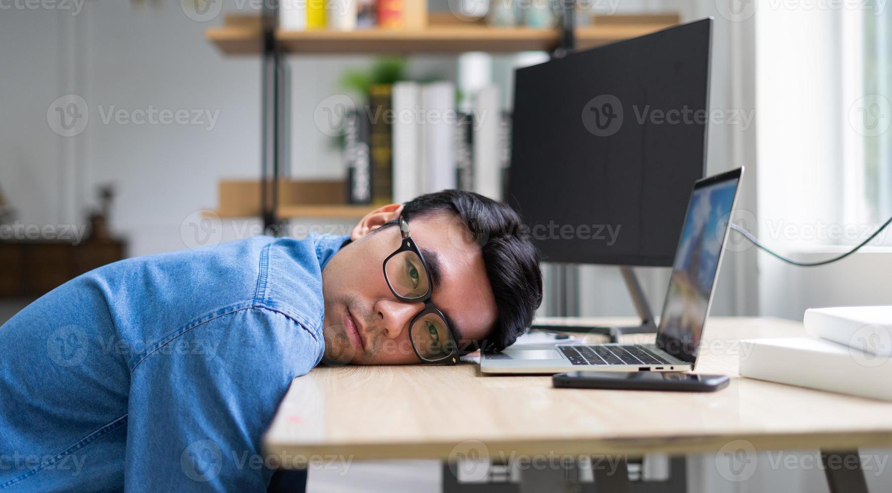 Young Asian man working at office photo