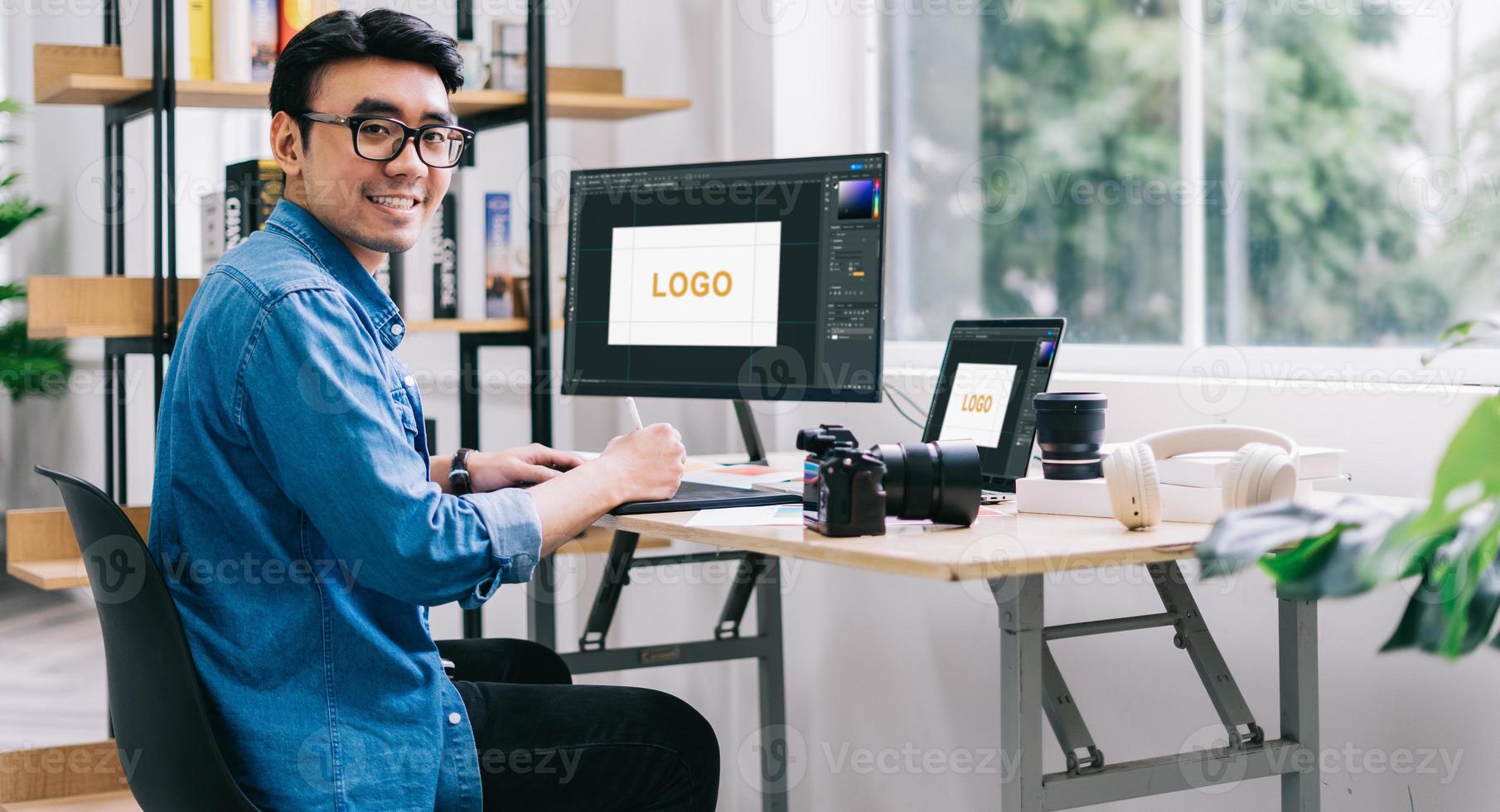 Young Asian designer working at office photo