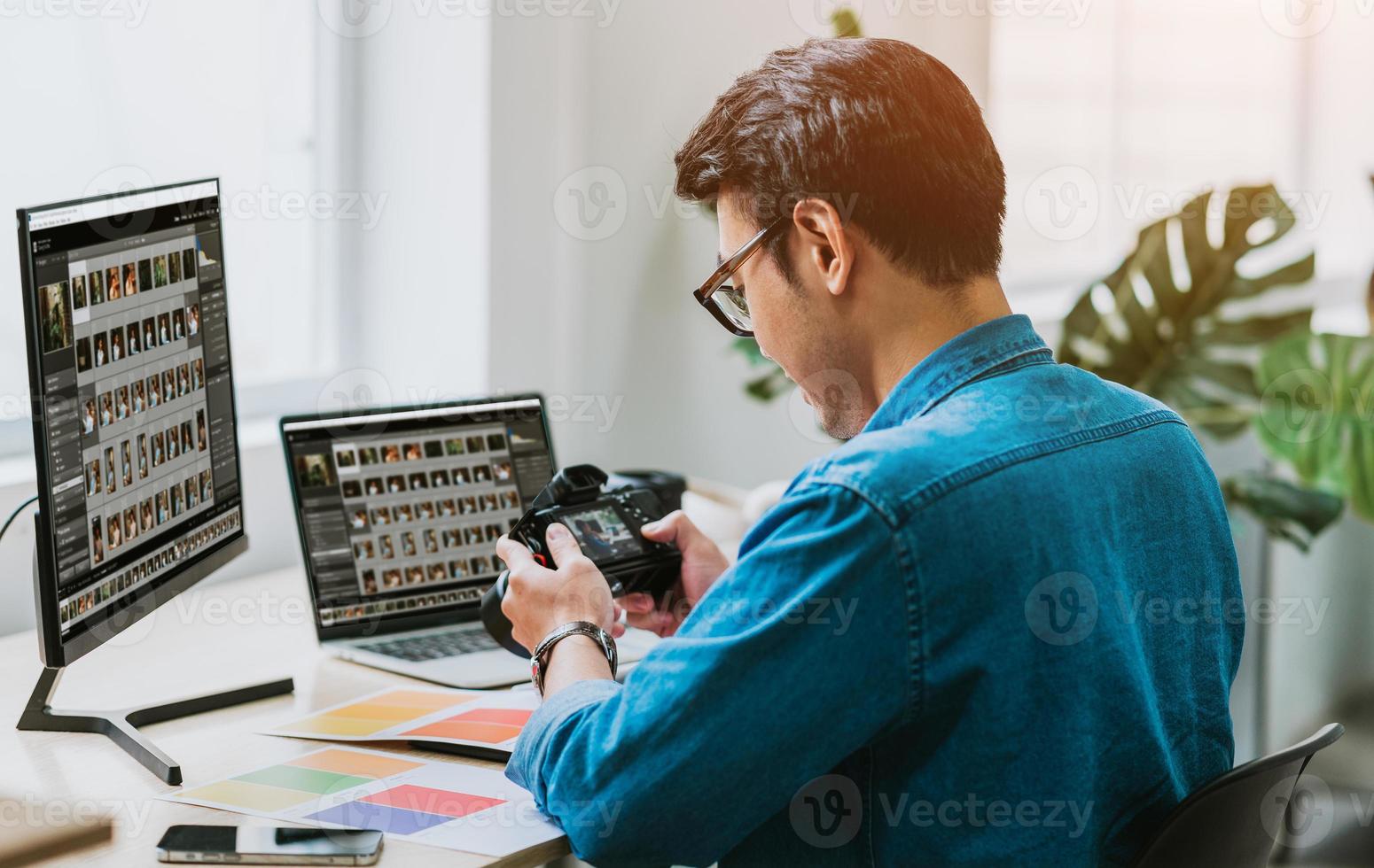 Young Asian photographer checking his photo