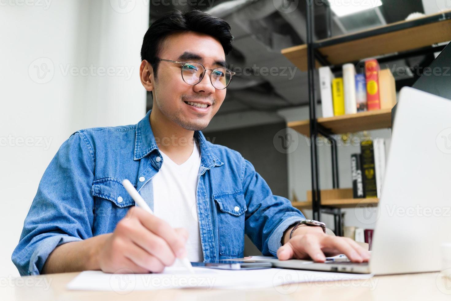 Young Asian man working at office photo