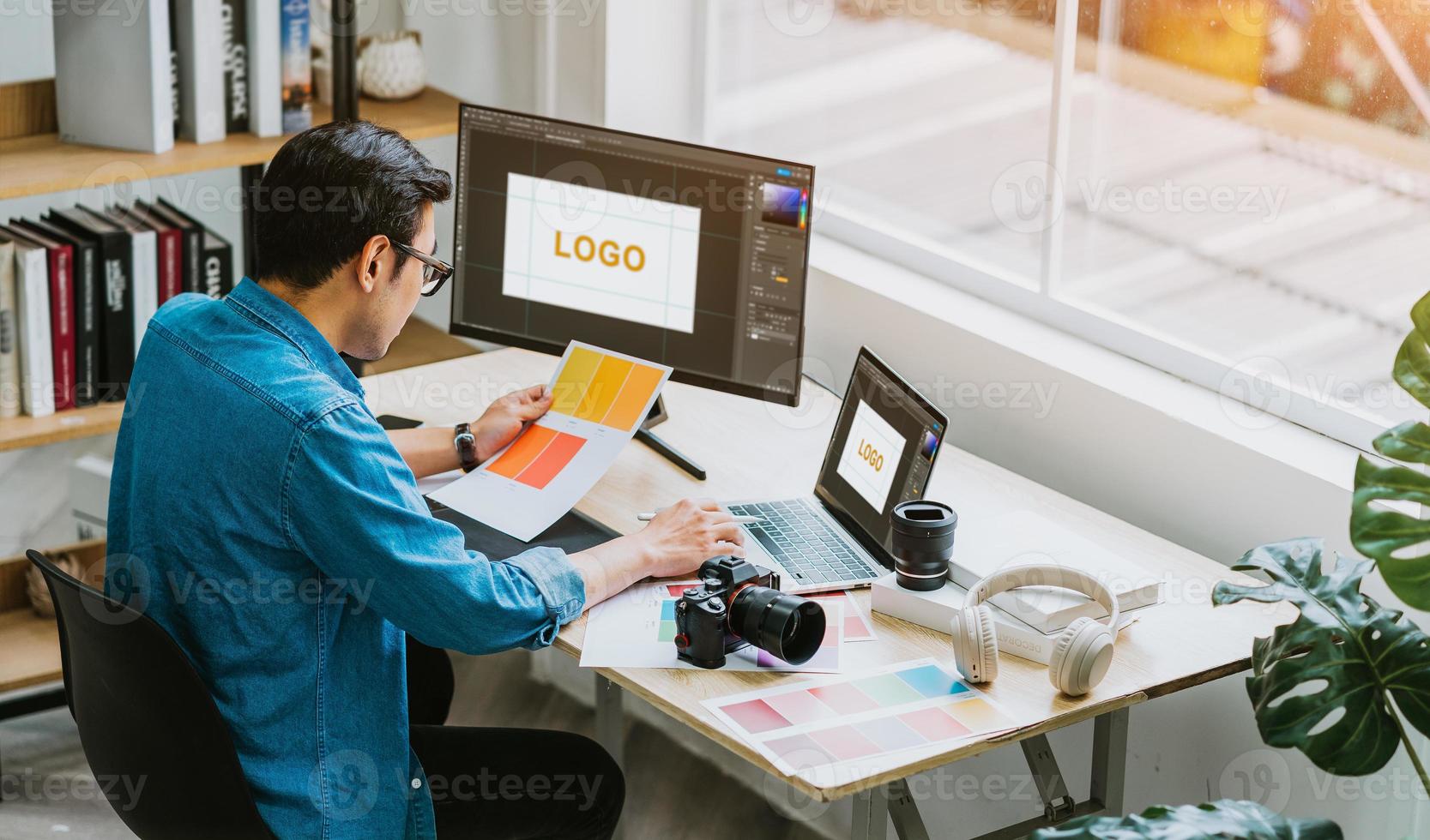 Young Asian designer working at office photo