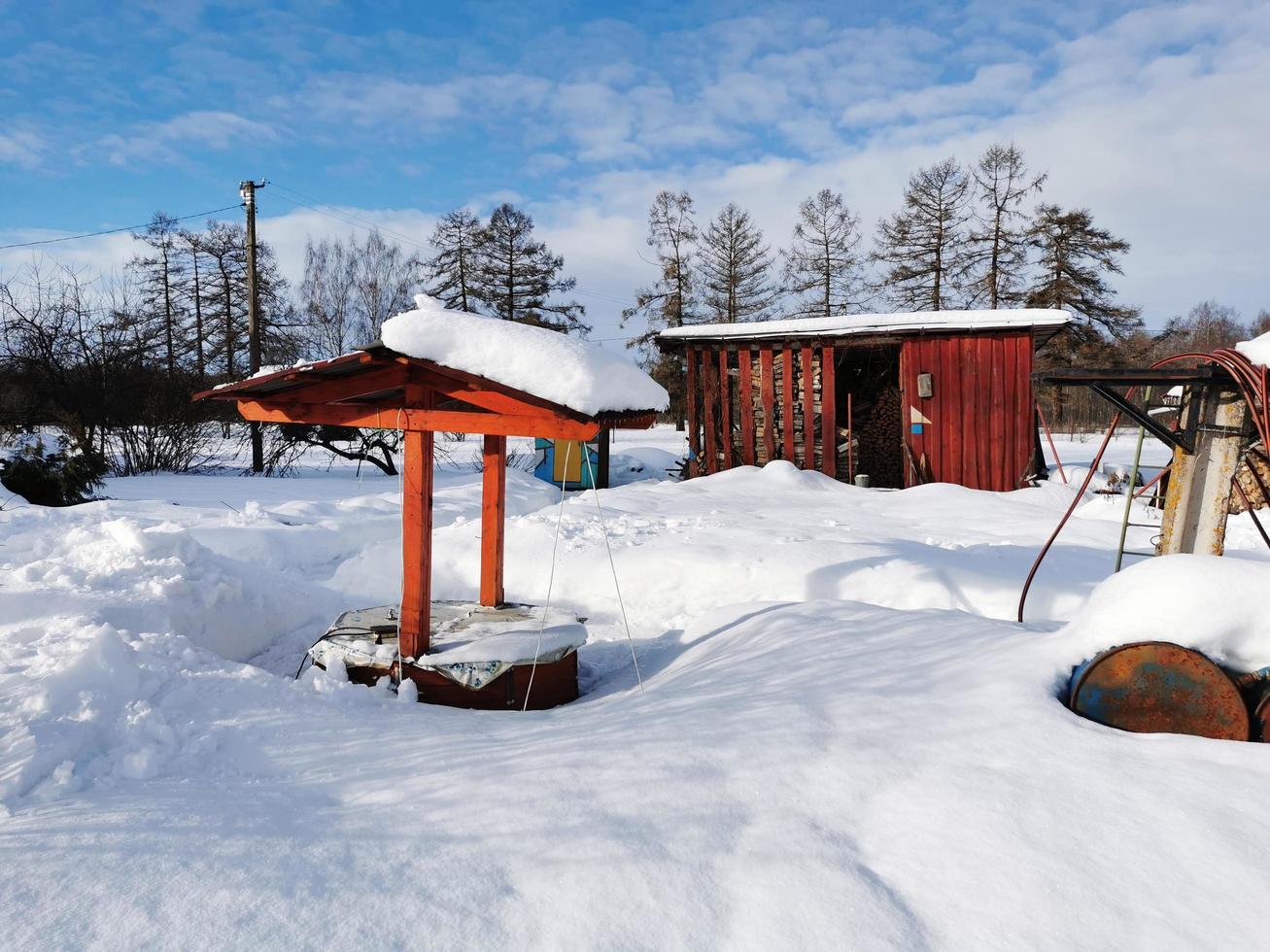 winter day in the Russian village snow well blue sky photo