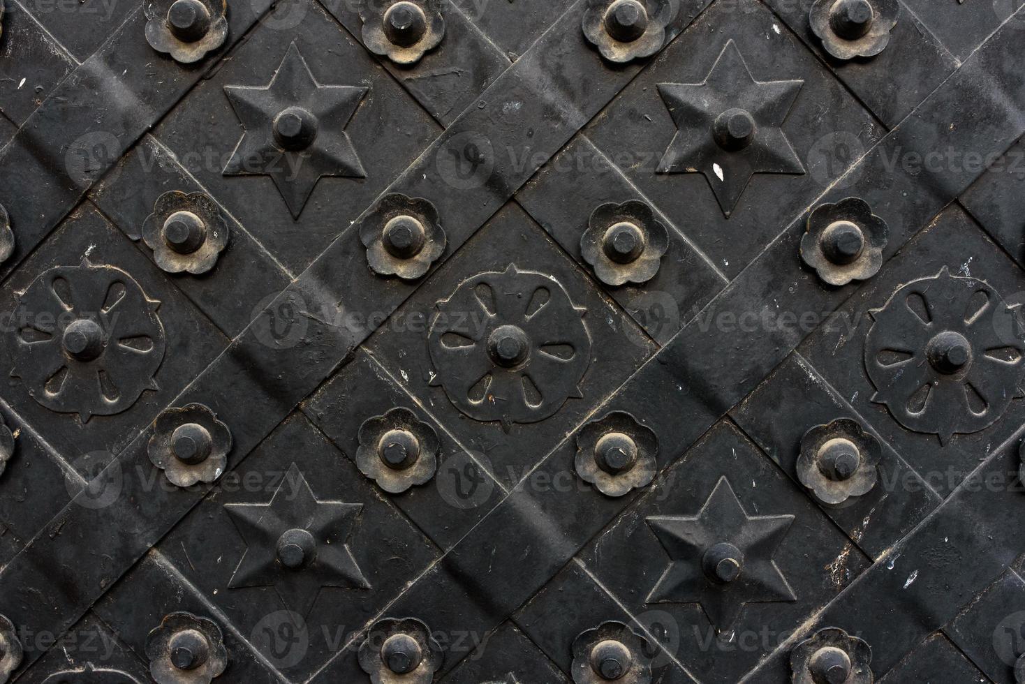 Black forged door, rhombus symmetrical texture. Grunge black background photo