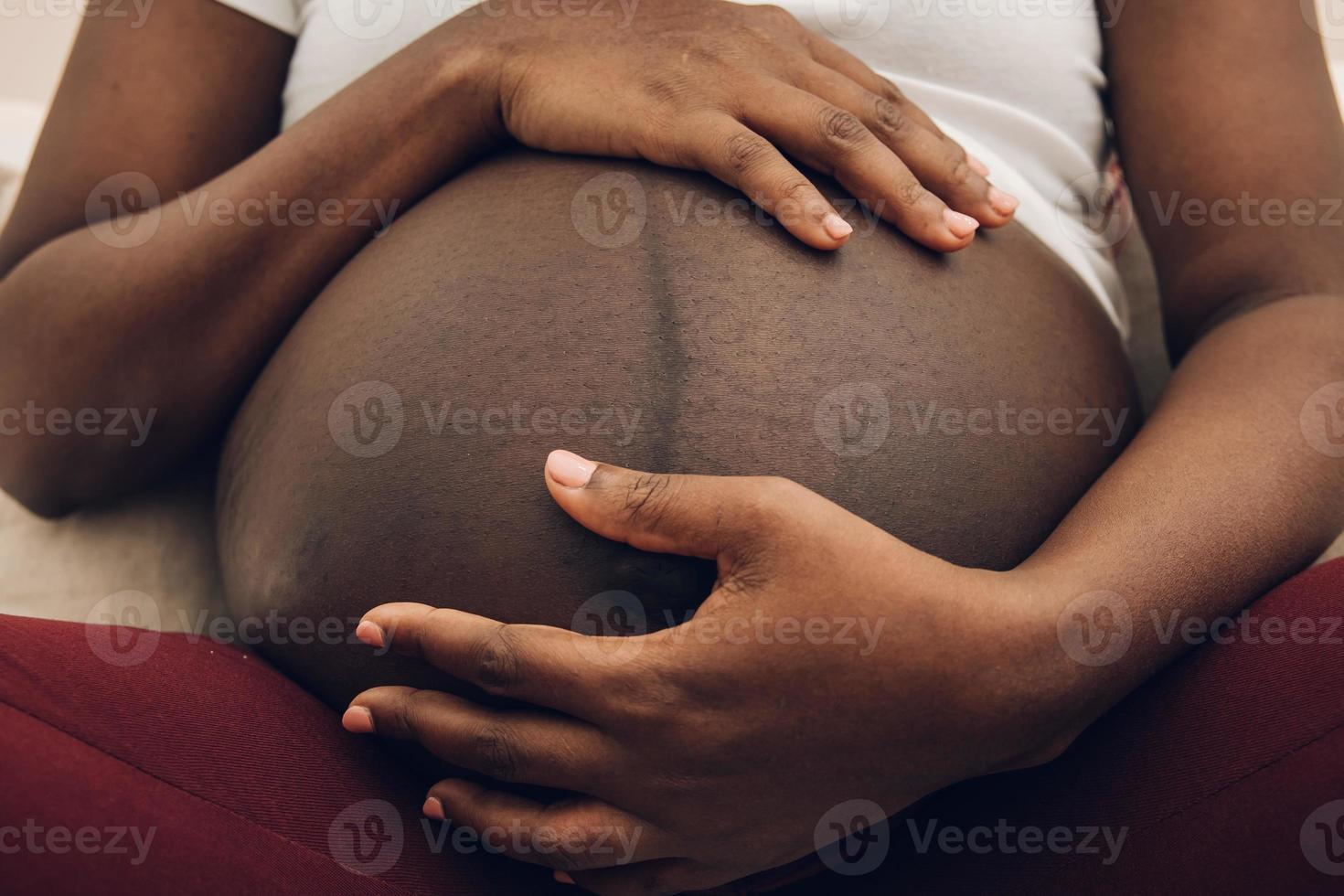 woman holding her belly  with his hands photo