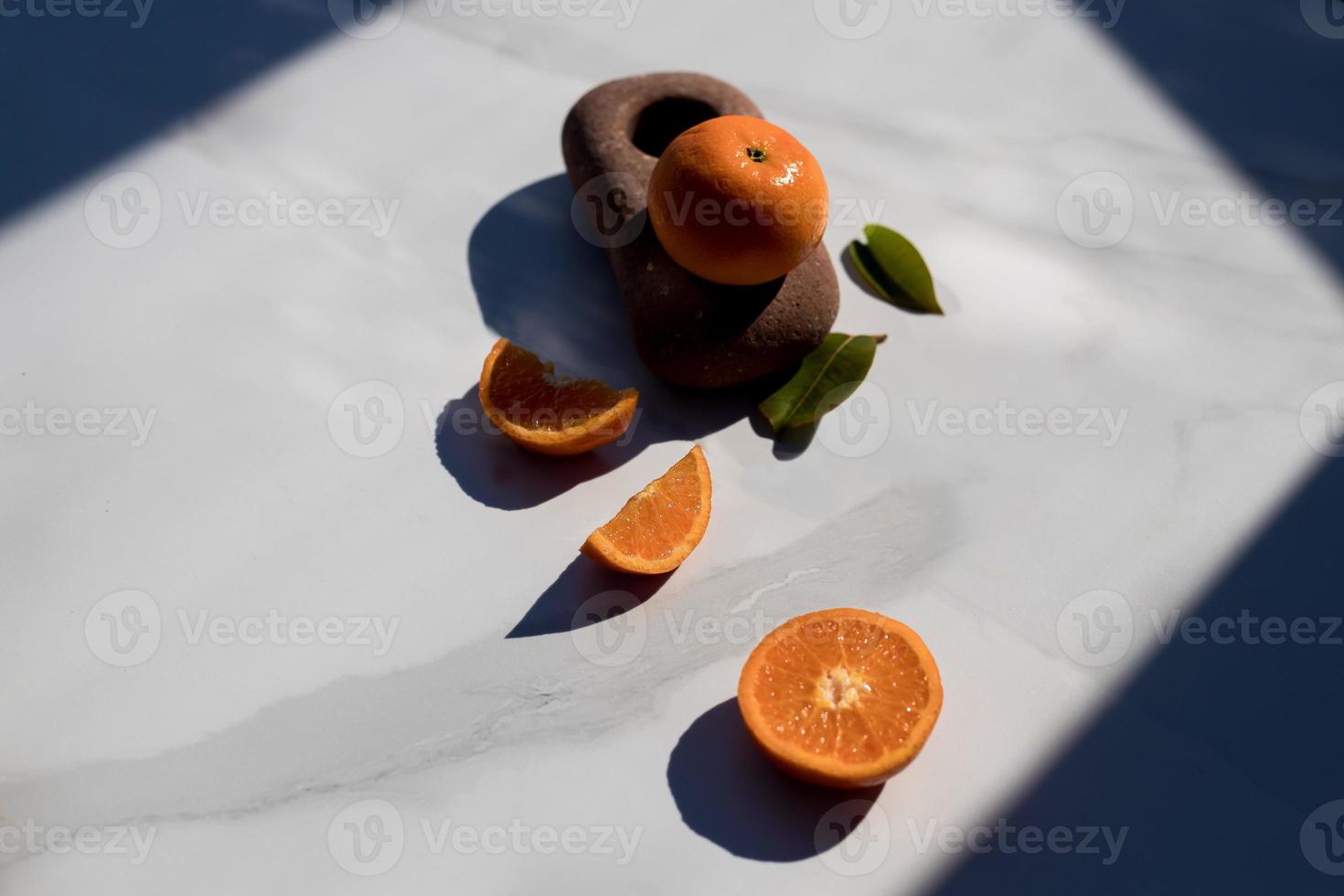 sliced mandarines on a white board photo