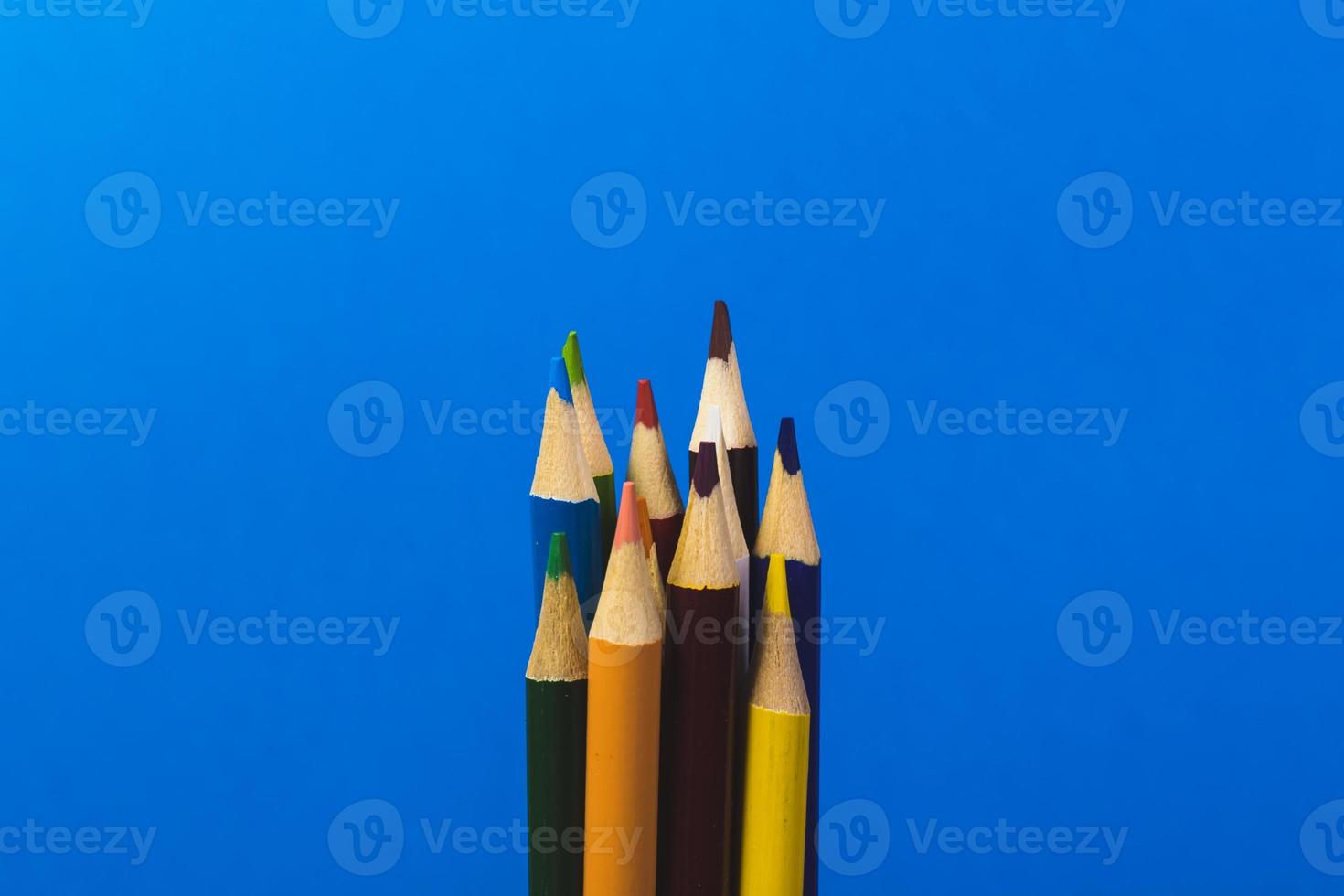 colored pencils on a blue background photo