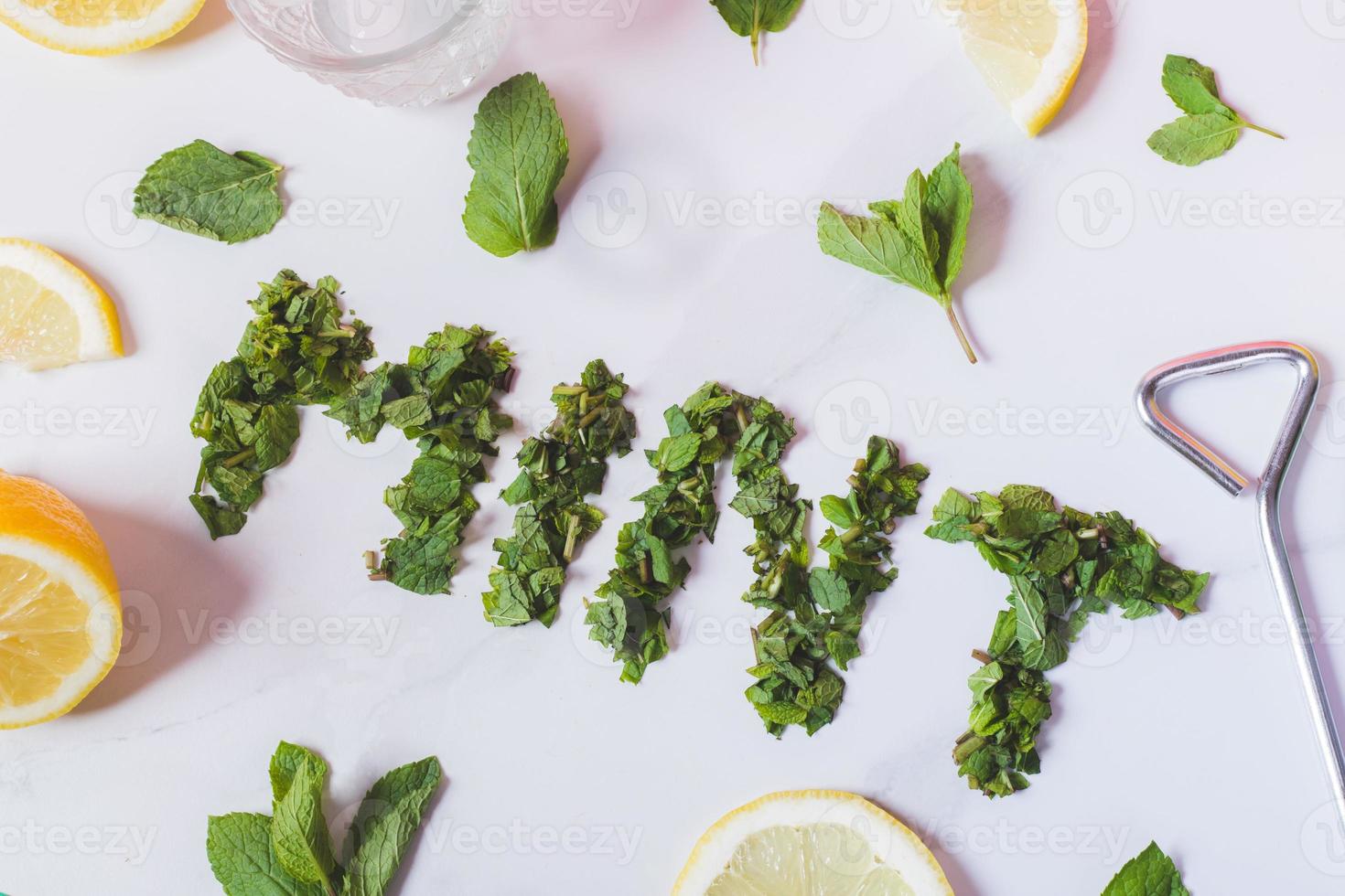 mind leaves and lemond slices on a white marble photo