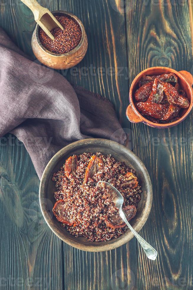 Portion of red quinoa with sun-dried tomatoes photo